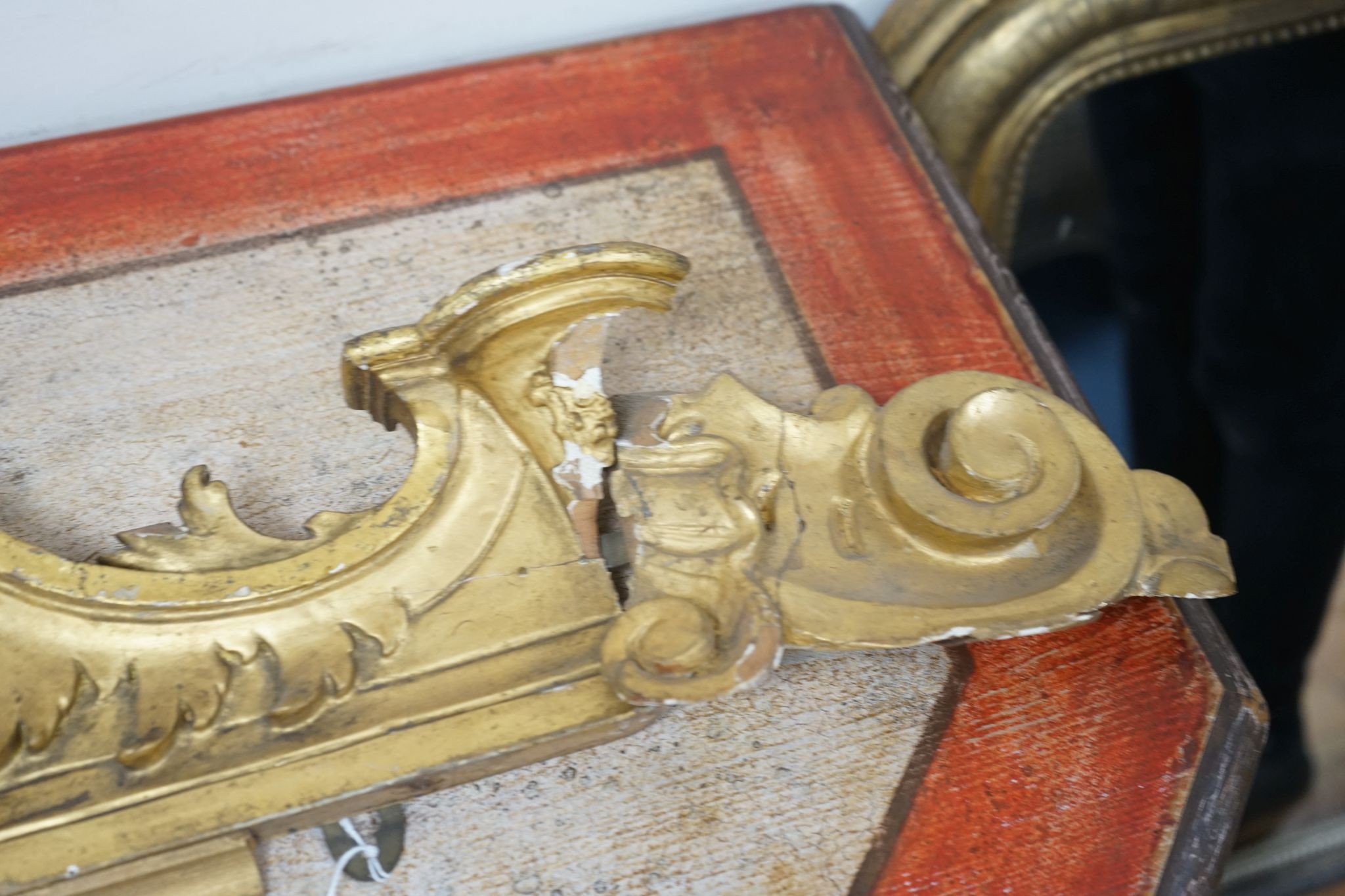 A 19th century carved giltwood pediment, width 142cm
